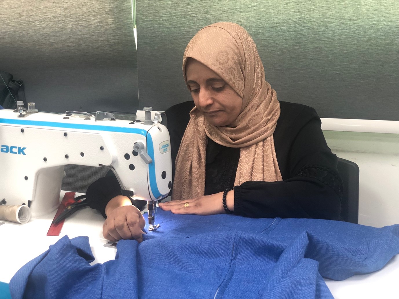 Alia, a mother and tailoring trainer, embodies empowerment and resilience at the Oasis Centre. 