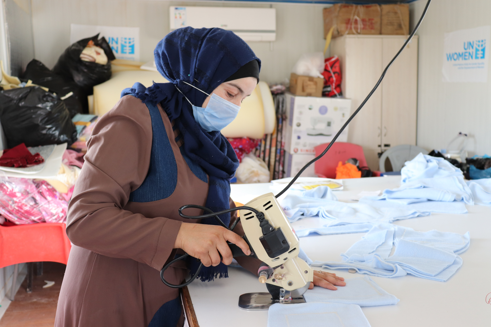 Marwa Barakat, 29, works on baby suits at the UN Women Oasis Centre in the Azraq refugee camp. Photo: UN Women/Tamara Abdin