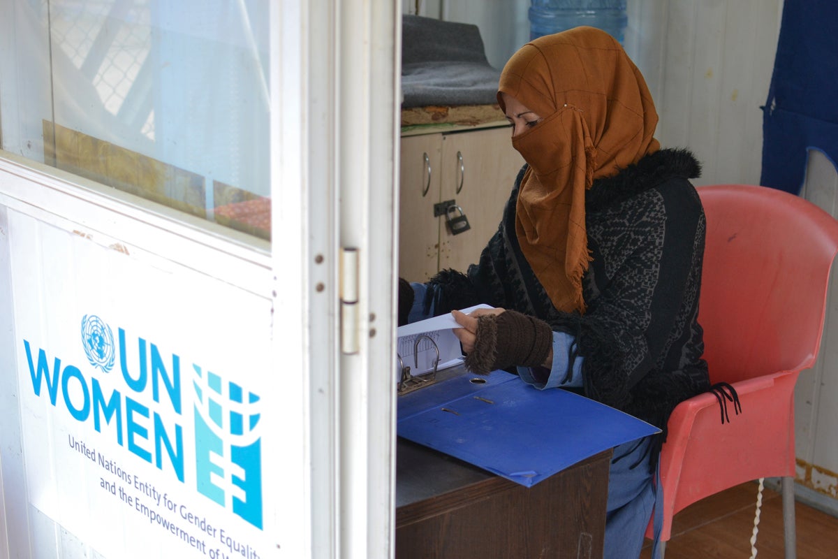 Samaher at the Zaatari Oasis centre taking notes as part of her tasks. 