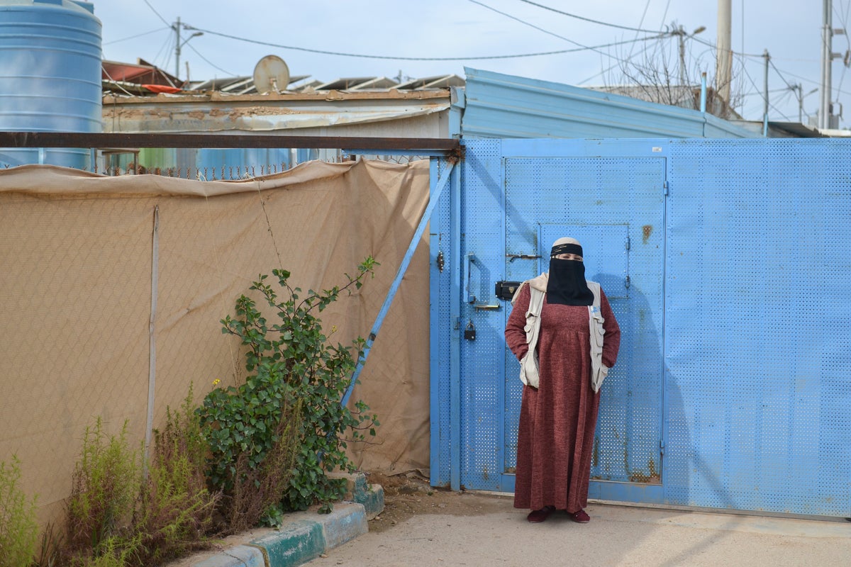 Fatima in front of the Zaatari Oasis centre gate where she works. 