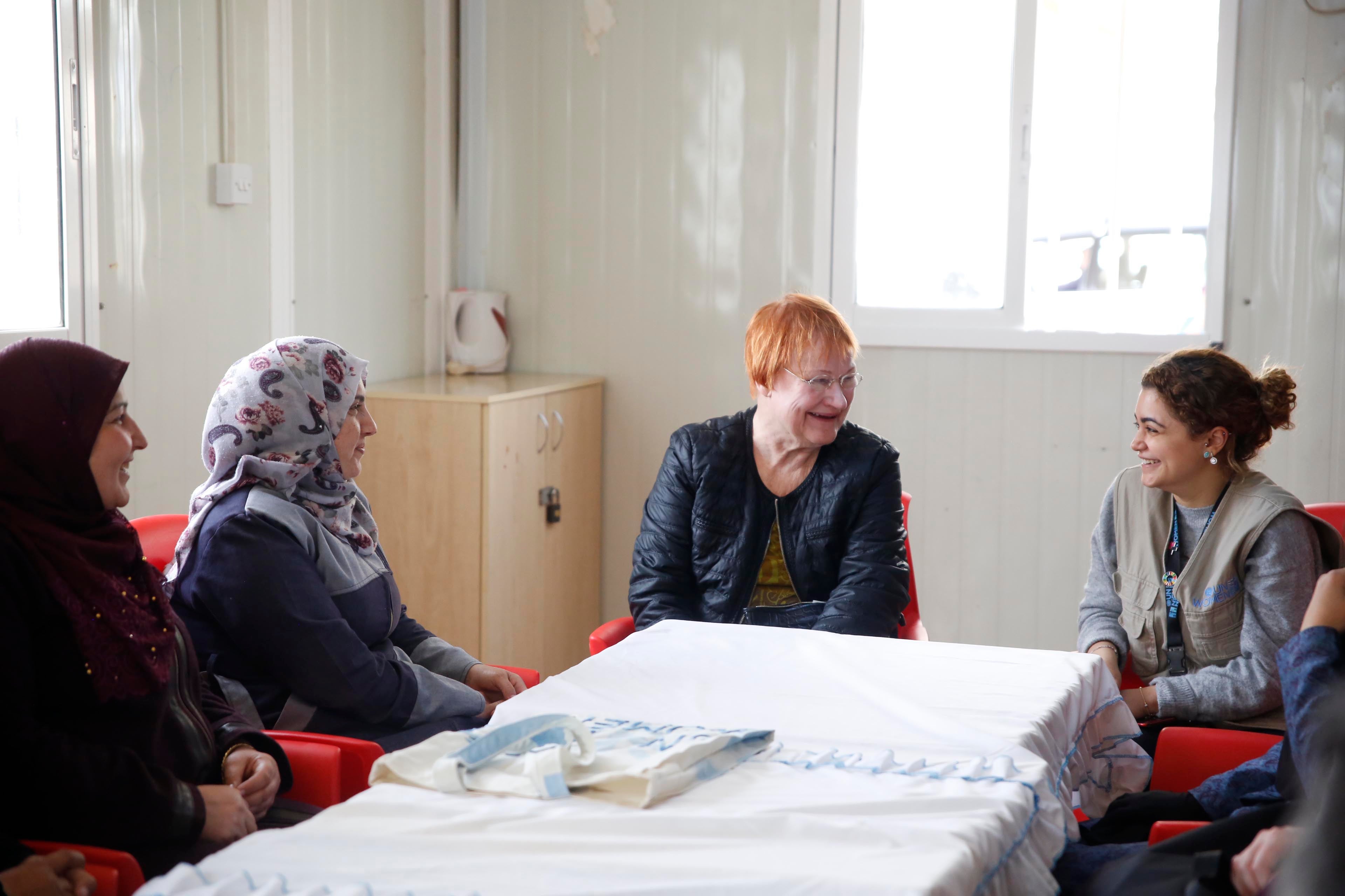 Communications specialist Susan Al Hilo translates for H.E Mrs. Tarja Halonen, in UN Women Oasis, Za'atari. Photo Source: UN Women/ Lauren Rooney