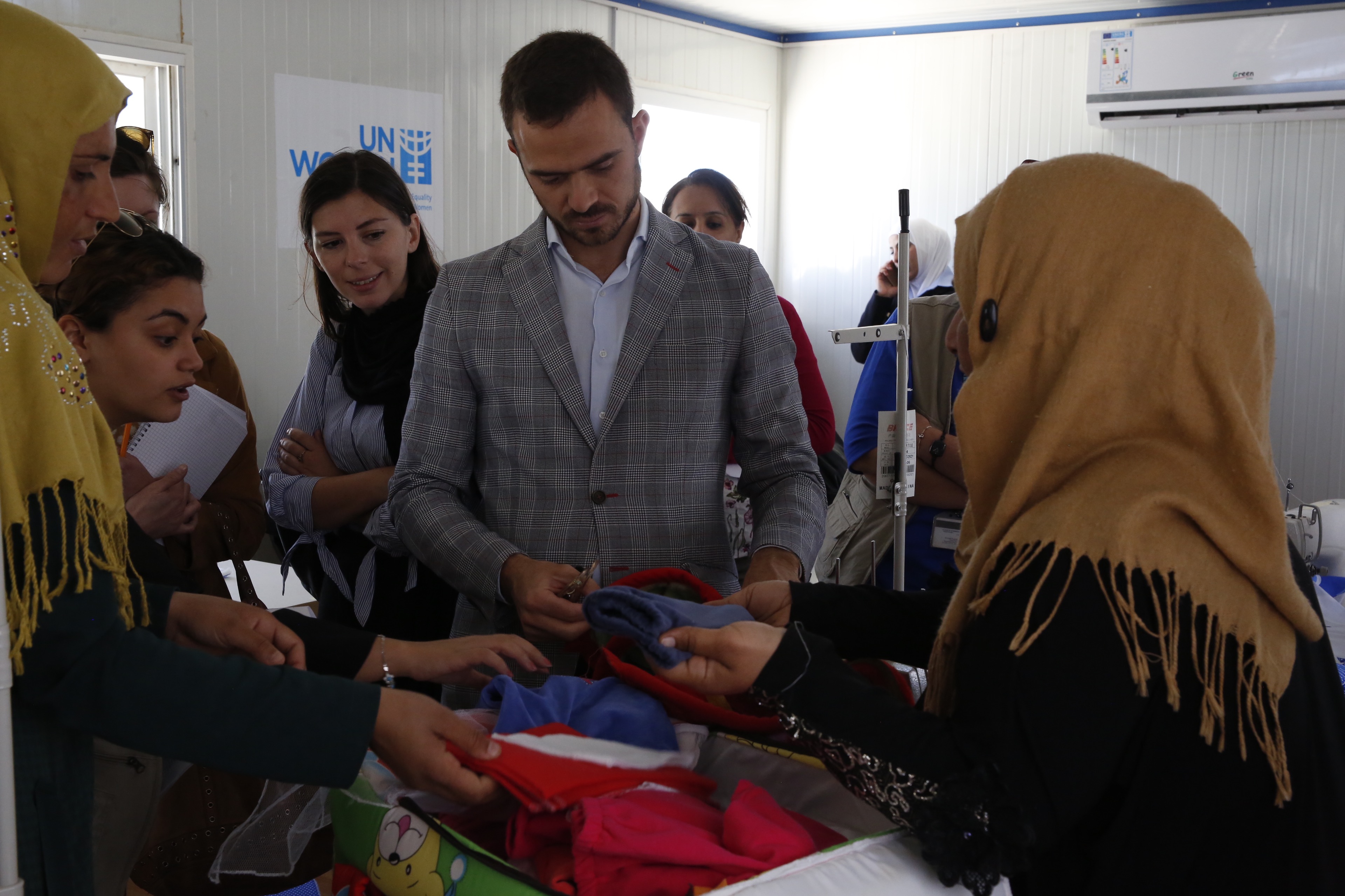 Visiting the tailoring facility, women present the baby kits that they manufacture. The production of the baby kits within the tailoring center are distributed through field hospitals to the more than 400 babies born in camp every month. 