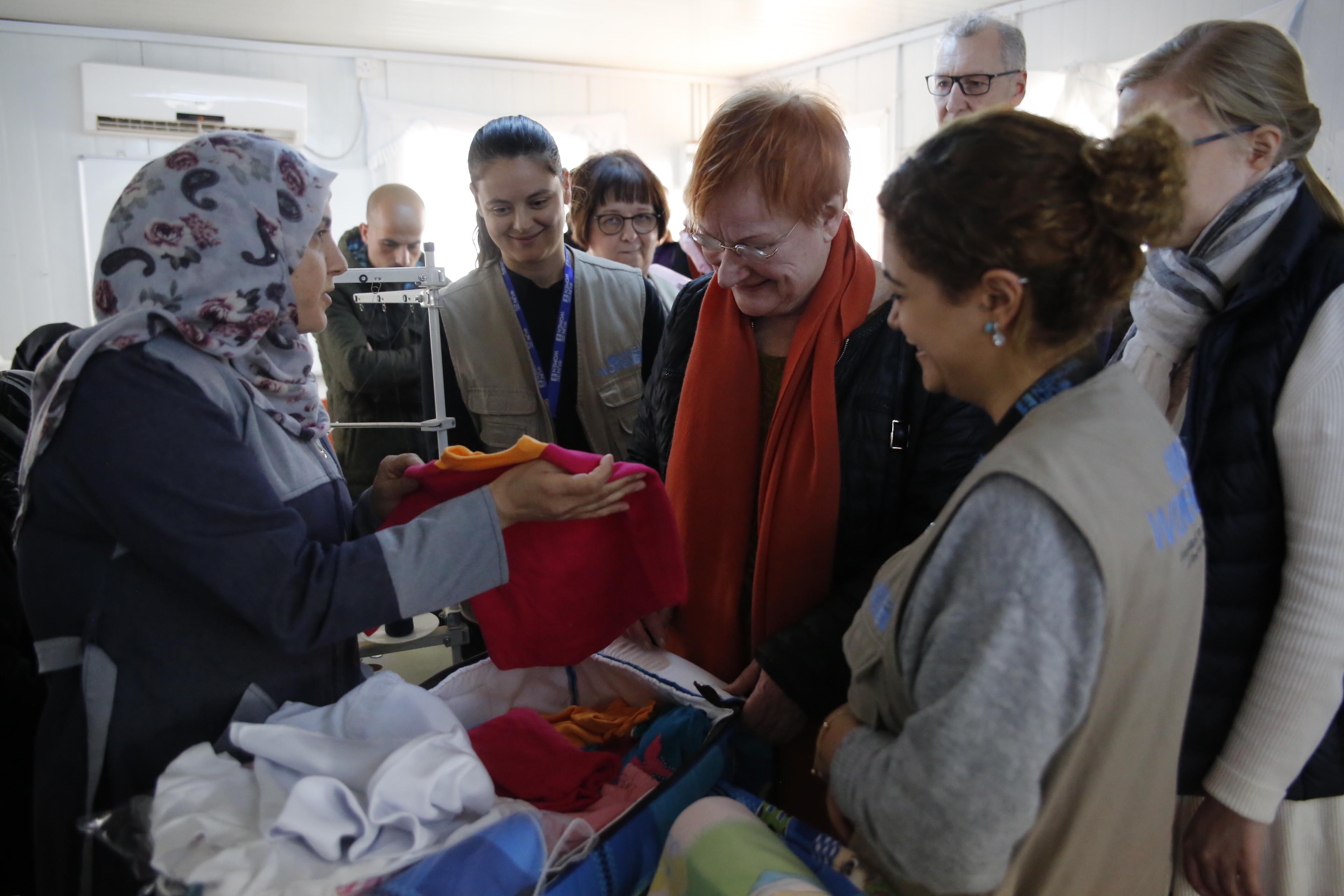 Tarja Halonen visits the Tailors who make Baby Kits for in camp mothers. 