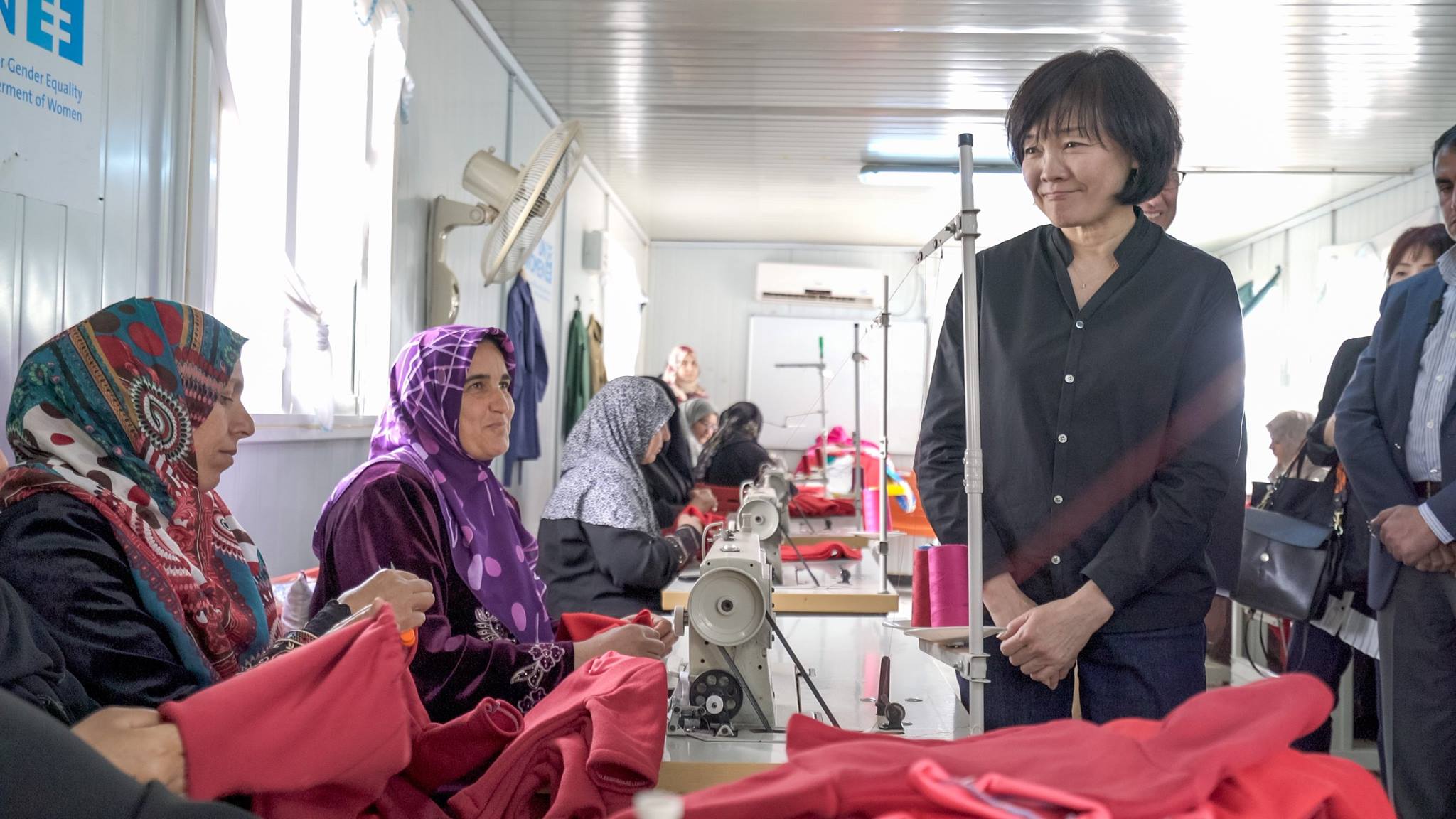 The First Lady, Mrs. Akie Abe visits the tailoring center within the Oasis, meeting the women crafting the baby kits that are distributed throughout the camp hospitals each month. Photo source UN Women/Christopher Herwig