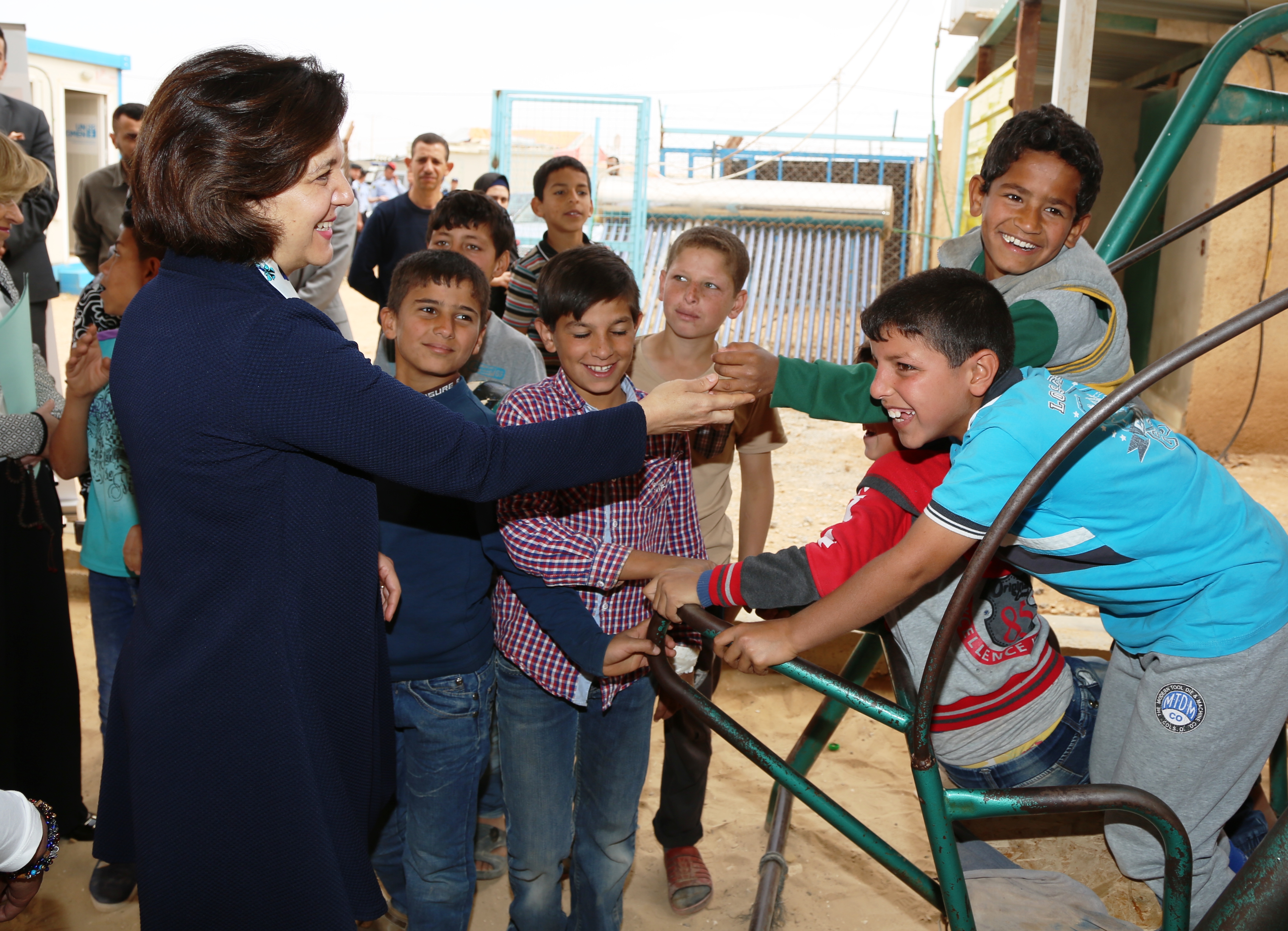 Minister of Social Development, H.E. Ms. Hala Lattouf greets children within the Oasis in Za'atari
