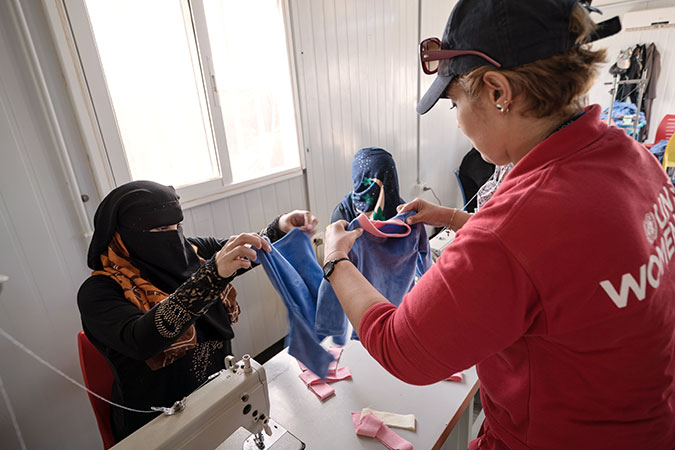 Hadeel, at right, leads the tailoring project, which is part of the cash-for-work programme, since she has a background in tailoring and fashion design. Photo: UN Women/Christopher Herwig