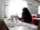 Noor Ali*, 35, is finally making her own decisions in life and learning to become economically empowered through her role as a tailor in the UN Women Oasis center in Azraq refugee camp, Jordan. Photo: UN Women/ Lauren Rooney